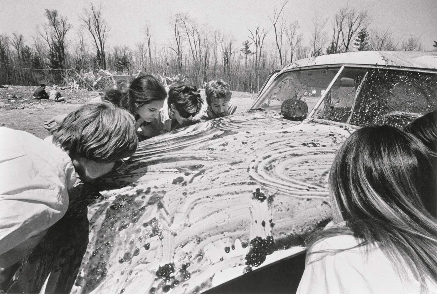  04. Women licking jam off a car 